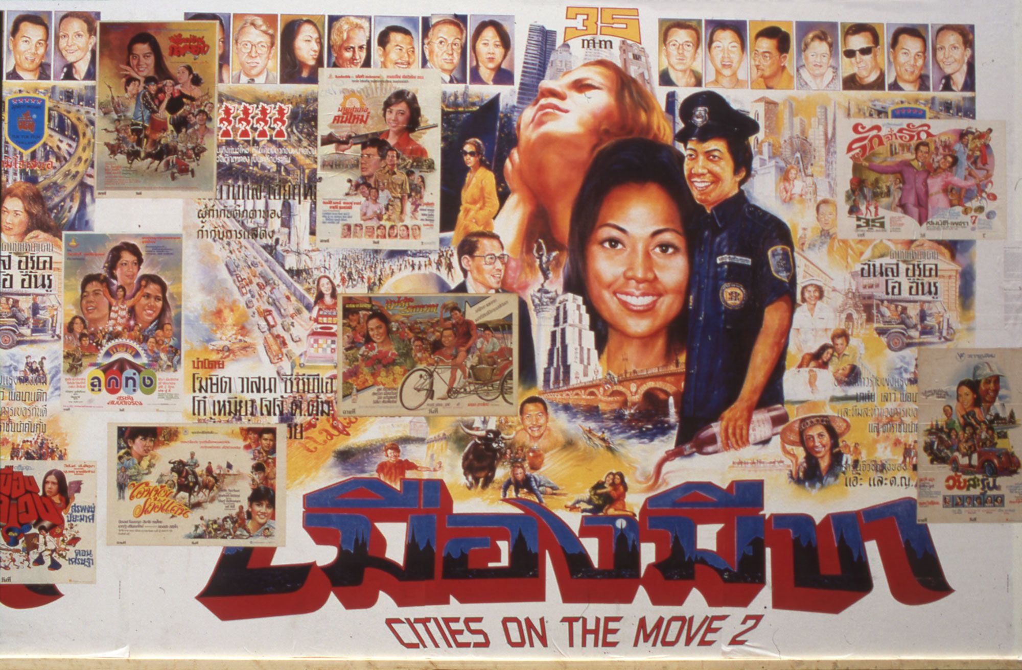 A white hoarding displays a large ‘Cities on the Move 2’ poster, titled in both Thai and English, overlaid with a number of colourful ‘Cities on the Move’ posters. These posters feature numerous people interspersed with urban scenes of cars on arterial roads and bicycles, styled reminiscently of sci-fi film posters.