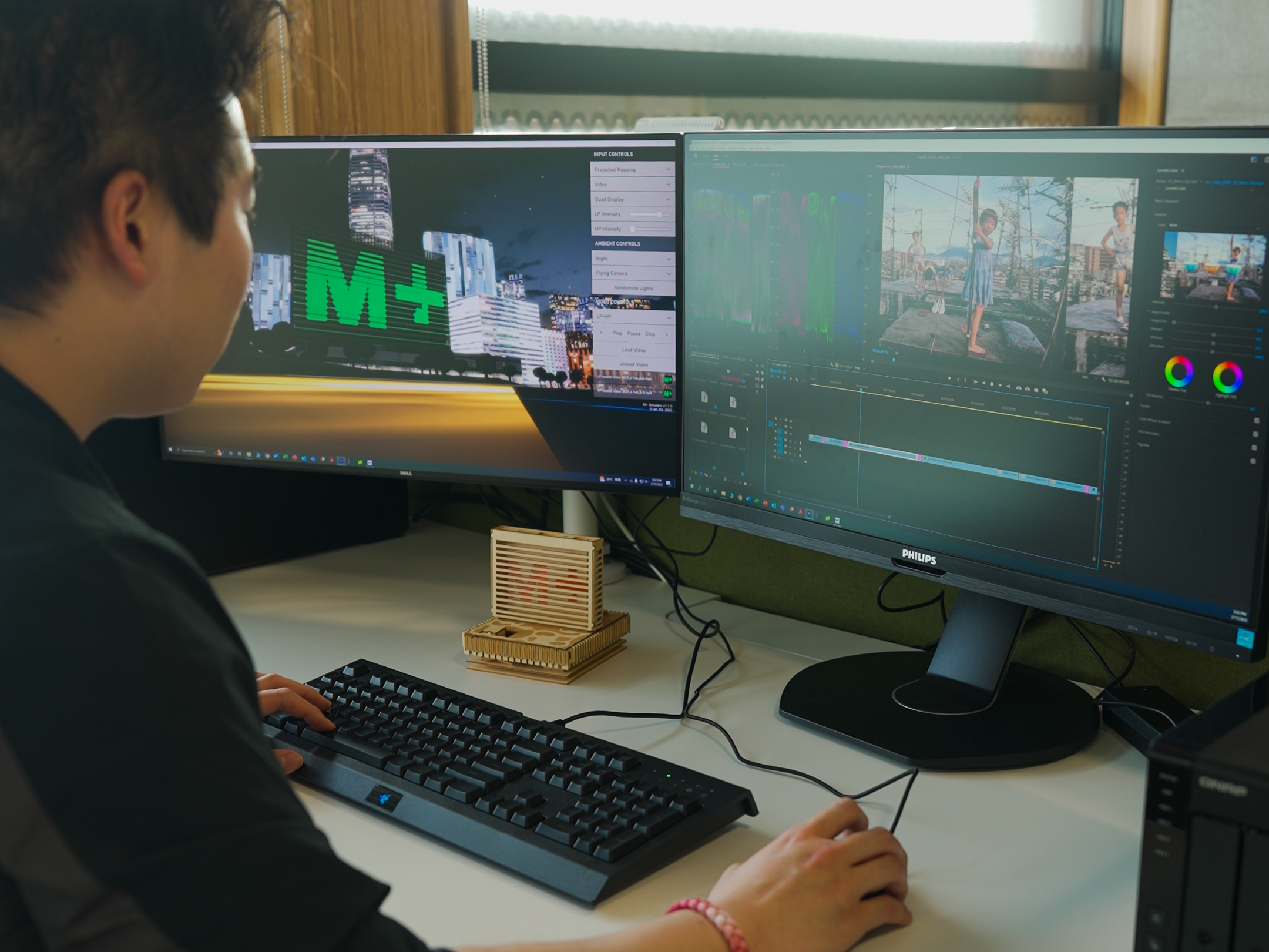 A man editing a video with software using two monitors.