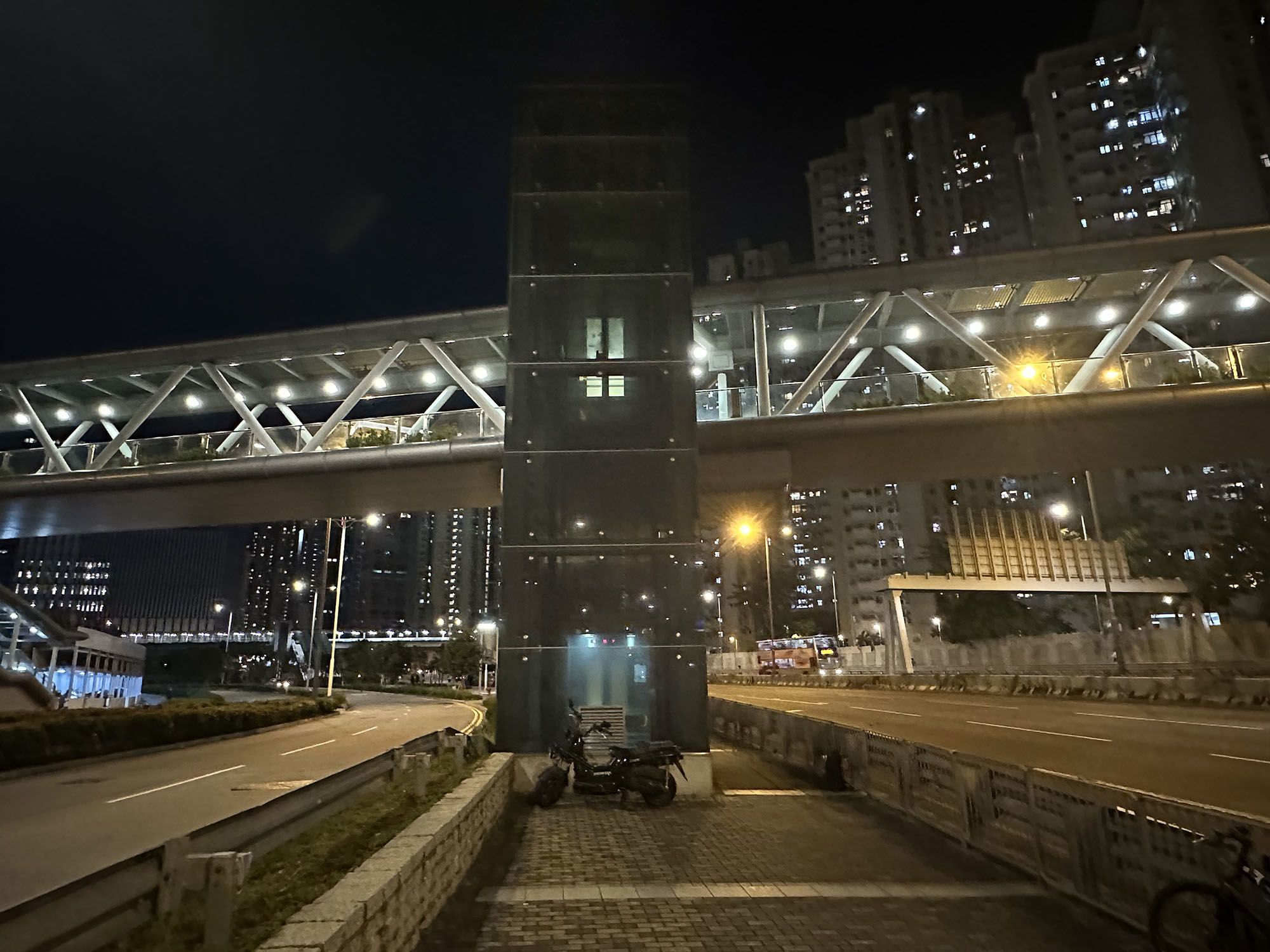 一部位于两条干道之间的升降机，在夜色中发光。